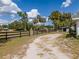 Picturesque land with a mix of grass, mature trees, and a secure black fence at 4145 Willis Rd, Mulberry, FL 33860
