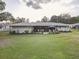 Spacious backyard with a covered patio, perfect for outdoor gatherings and relaxation at 5811 Lake Breeze Ave, Lakeland, FL 33809