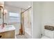 Bright bathroom featuring marble-look tile, neutral walls, and a modern vanity with updated fixtures at 5811 Lake Breeze Ave, Lakeland, FL 33809