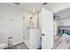 Bathroom featuring double sinks, a glass enclosed shower, and light gray wood-look floors at 5811 Lake Breeze Ave, Lakeland, FL 33809