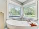 Bathroom with soaking tub that features picture window with lots of natural light at 5811 Lake Breeze Ave, Lakeland, FL 33809