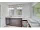 Bright bathroom featuring double vanity, marble countertops and a changing station at 5811 Lake Breeze Ave, Lakeland, FL 33809