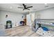 Bedroom featuring a ceiling fan, light gray wood-look floors, and a bunk bed at 5811 Lake Breeze Ave, Lakeland, FL 33809
