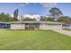 Well-maintained single-story home with a lush front lawn and attached garage at 5811 Lake Breeze Ave, Lakeland, FL 33809