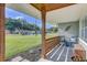 Relaxing front porch with wood columns, outdoor seating, and a view of the neighborhood at 5811 Lake Breeze Ave, Lakeland, FL 33809