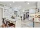Modern kitchen features stainless steel appliances, marble countertops, and a breakfast bar with seating at 5811 Lake Breeze Ave, Lakeland, FL 33809