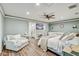 Spacious main bedroom with accent wall, ceiling fan, hardwood floors and sitting area at 5811 Lake Breeze Ave, Lakeland, FL 33809