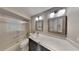 Bathroom featuring shower over tub with a glass screen, white countertops and dark cabinets at 699 Sullivan St, Deltona, FL 32725