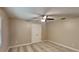 This bedroom features neutral walls, a ceiling fan, and a closet with white doors at 699 Sullivan St, Deltona, FL 32725