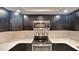 Stylish kitchen featuring dark cabinets, stainless steel appliances, and light countertops at 699 Sullivan St, Deltona, FL 32725