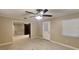 Open-concept living room with tiled floors, a ceiling fan, and a view into the kitchen at 699 Sullivan St, Deltona, FL 32725