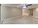 Spacious living room featuring neutral paint, tiled flooring, a ceiling fan, and access to other parts of the home at 699 Sullivan St, Deltona, FL 32725