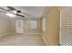 Bright and airy living room showcasing tiled floors, neutral paint, an overhead ceiling fan, and ample natural light at 699 Sullivan St, Deltona, FL 32725