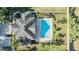 Aerial view of a home with a backyard pool and palm trees creating a private oasis at 1035 Stoney Creek Dr, Lakeland, FL 33811