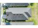 Birds eye view of a home's roof, complemented by well-manicured lawns and neighboring houses at 1035 Stoney Creek Dr, Lakeland, FL 33811