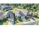 Aerial view of a well-maintained home with a dark roof, surrounded by lush greenery and neighborhood streets at 1035 Stoney Creek Dr, Lakeland, FL 33811