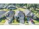 Aerial view of a well-maintained home with a dark roof, surrounded by lush greenery and neighborhood streets at 1035 Stoney Creek Dr, Lakeland, FL 33811