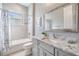 Well-lit bathroom with marble countertop, shower-tub combo, and tiled walls at 1035 Stoney Creek Dr, Lakeland, FL 33811