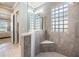 Bathroom featuring walk-in shower, glass block detail, and modern fixtures at 1035 Stoney Creek Dr, Lakeland, FL 33811