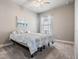 This cozy bedroom features neutral walls, soft carpet, and a beautiful sailboat-themed art piece at 1035 Stoney Creek Dr, Lakeland, FL 33811
