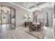 Formal dining room with stylish chandelier, elegant decor, and a large window for natural light at 1035 Stoney Creek Dr, Lakeland, FL 33811