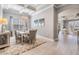 Elegant dining room with coffered ceiling, chandelier, neutral decor, and wood-look floors at 1035 Stoney Creek Dr, Lakeland, FL 33811