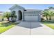 Charming home featuring a two-car garage, arched entryway, and well-maintained landscaping at 1035 Stoney Creek Dr, Lakeland, FL 33811