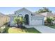 Charming one-story home featuring a two-car garage and a well-manicured front yard with lush green grass at 1035 Stoney Creek Dr, Lakeland, FL 33811