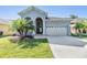 Charming one-story home featuring a two-car garage and a well-manicured front yard with lush green grass at 1035 Stoney Creek Dr, Lakeland, FL 33811