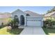Charming one-story home featuring a two-car garage and a well-manicured front yard with lush green grass at 1035 Stoney Creek Dr, Lakeland, FL 33811