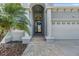 Elegant entryway with a decorative door, stylish columns, and meticulously paved walkway at 1035 Stoney Creek Dr, Lakeland, FL 33811