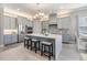 Modern kitchen featuring stainless steel appliances, a center island with seating, and stylish gray cabinetry at 1035 Stoney Creek Dr, Lakeland, FL 33811