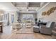 Bright living room featuring a coffered ceiling, neutral decor, and large windows overlooking the yard at 1035 Stoney Creek Dr, Lakeland, FL 33811