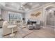 Bright living room with tray ceiling, fireplace, neutral decor and sliding glass doors to outdoors at 1035 Stoney Creek Dr, Lakeland, FL 33811