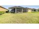 Screened-in porch extends living space to the backyard, enhancing the home's appeal for outdoor enjoyment at 1035 Stoney Creek Dr, Lakeland, FL 33811