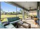 Inviting screened porch with comfortable seating, an outdoor ceiling fan, and views of the yard at 1035 Stoney Creek Dr, Lakeland, FL 33811
