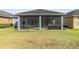 Enclosed screened porch creates a cozy outdoor lounge with comfortable seating, ideal for relaxation at 1035 Stoney Creek Dr, Lakeland, FL 33811