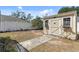 Backyard shed with flower boxes, a stone path, and access to the yard at 133 Grovepark Dr, Davenport, FL 33837
