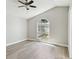 Bright bedroom with wood flooring, a ceiling fan, and a large arched window at 133 Grovepark Dr, Davenport, FL 33837