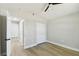 This is a clean, empty bedroom with light wood vinyl floors, white door and trim, and a ceiling fan at 133 Grovepark Dr, Davenport, FL 33837