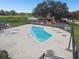 This community pool with lounge chairs is adjacent to the neighborhood playground at 133 Grovepark Dr, Davenport, FL 33837