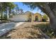 Charming single-Gathering home with a two-car garage, manicured lawn and beautiful trees at 133 Grovepark Dr, Davenport, FL 33837