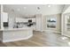 Bright kitchen featuring quartz countertops, stainless steel appliances, and light modern cabinets at 133 Grovepark Dr, Davenport, FL 33837
