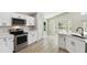 Bright, remodeled kitchen with stainless steel appliances and a seamless backsplash at 133 Grovepark Dr, Davenport, FL 33837