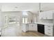 Bright kitchen features white cabinetry, an island with a sink, and brand-new black appliances at 133 Grovepark Dr, Davenport, FL 33837