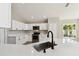 Beautiful updated kitchen with stainless steel appliances, quartz countertops, and white cabinets at 133 Grovepark Dr, Davenport, FL 33837