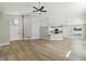Bright living room with sleek, modern floors and an open concept to the kitchen at 133 Grovepark Dr, Davenport, FL 33837