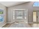 Light-filled living room with backyard views from large windows and updated flooring at 133 Grovepark Dr, Davenport, FL 33837