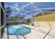 Screened-in pool features a custom shape, bright blue water, and a light concrete deck at 133 Grovepark Dr, Davenport, FL 33837