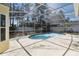 This is a screened-in pool with a view of landscaping in the backyard of the home at 133 Grovepark Dr, Davenport, FL 33837